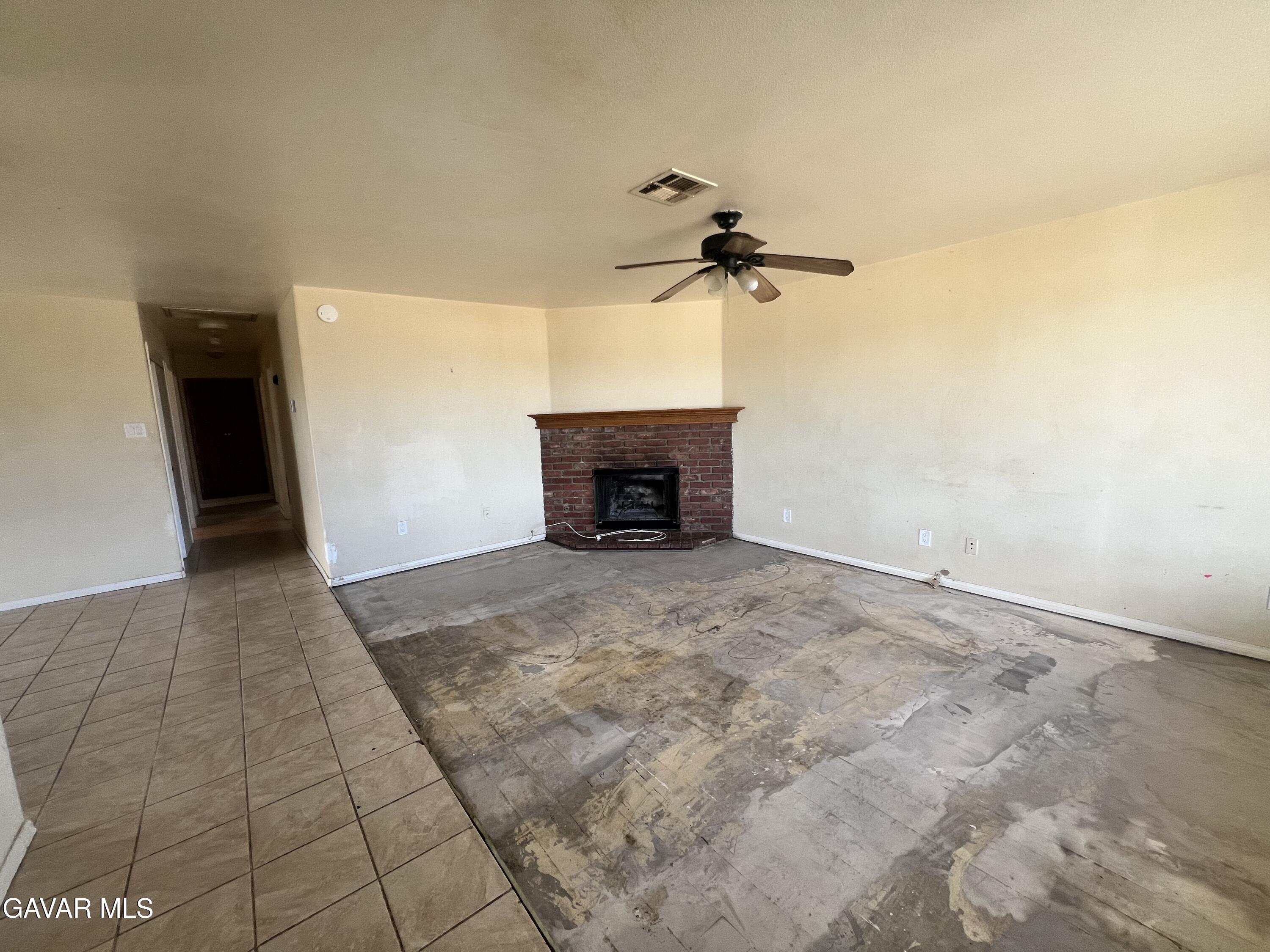 13632 Fran Street North Edwards, CA 93523 - Photo 3 of 18 a view of an empty room with a fireplace