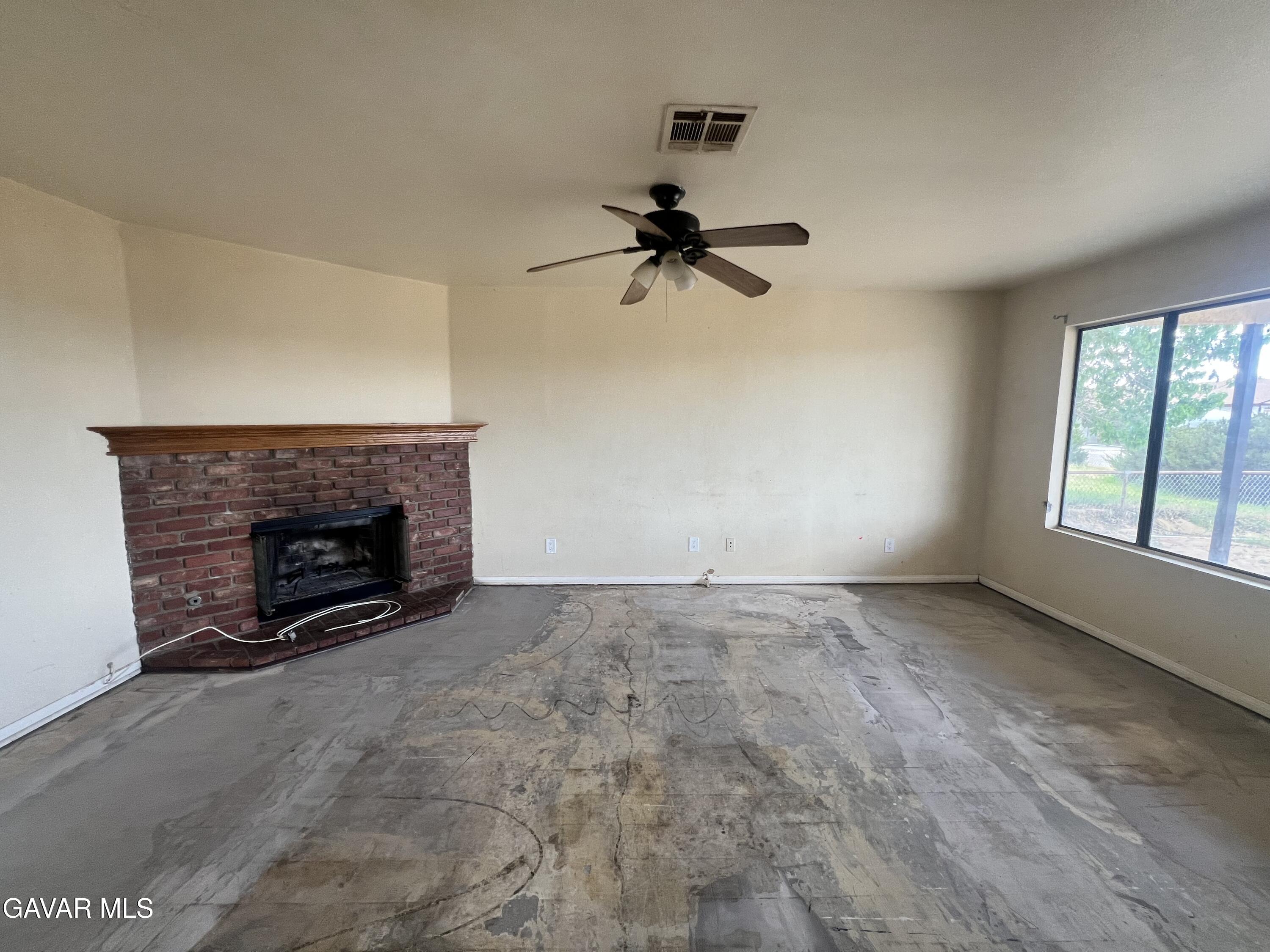 13632 Fran Street North Edwards, CA 93523 - Photo 4 of 18 a view of an empty room with windows and fireplace