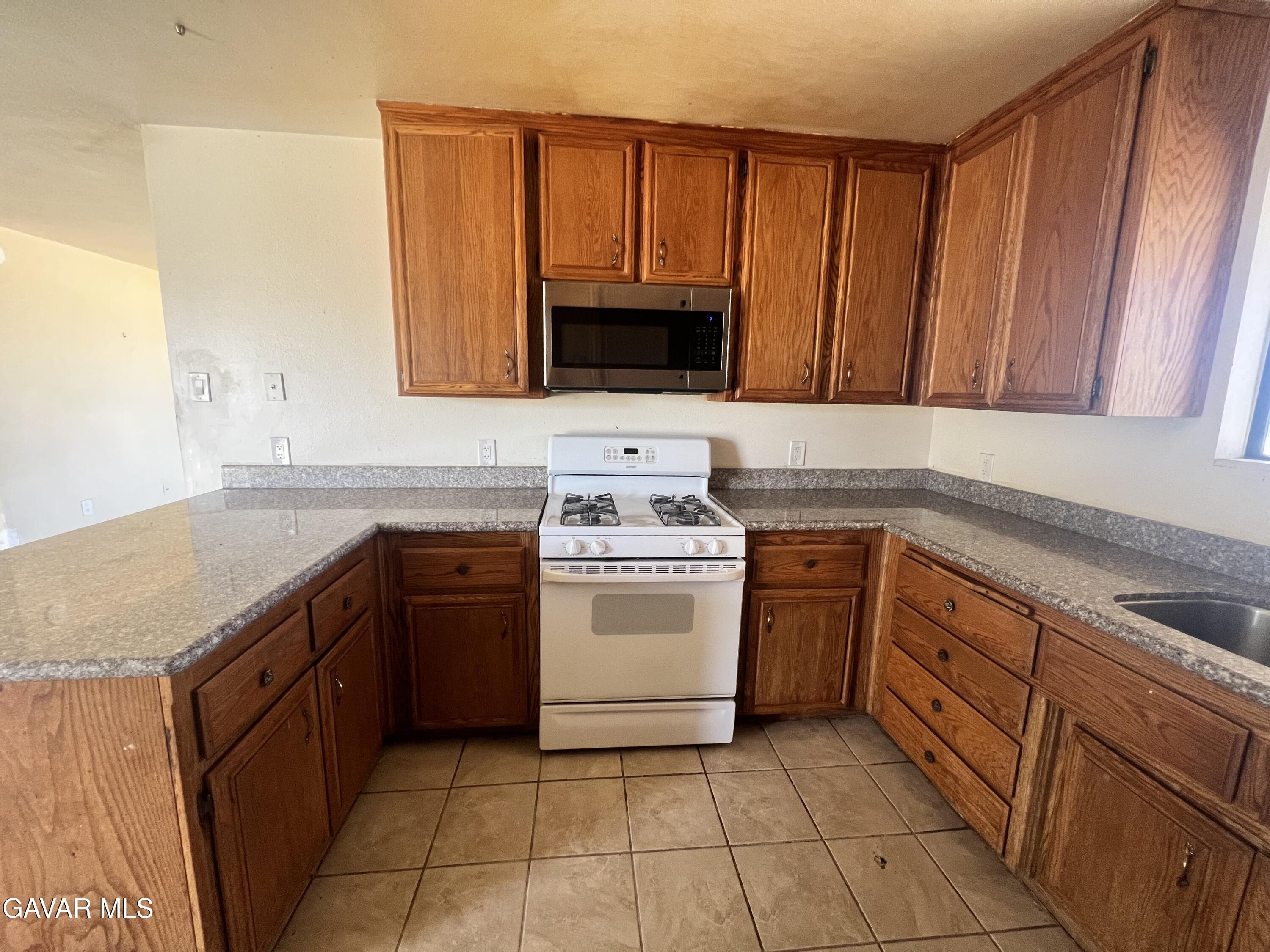 13632 Fran Street North Edwards, CA 93523 - Photo 10 of 18 a kitchen with a stove sink and cabinets