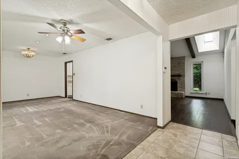 a view of an empty room with a ceiling fan