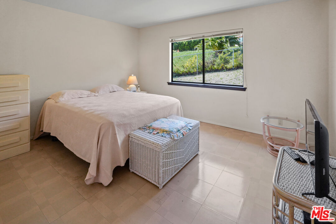 6405 Sycamore Meadows Drive Malibu, CA 90265 - Photo 17 of 26 a bedroom with a bed closet and a window