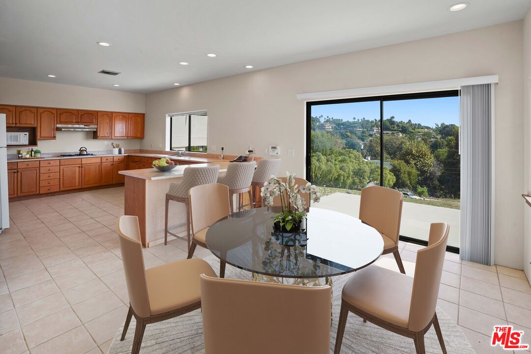 6405 Sycamore Meadows Drive Malibu, CA 90265 - Photo 6 of 26 a dining room with furniture and a floor to ceiling window