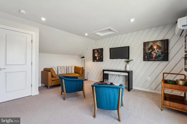 a living room with furniture and large windows