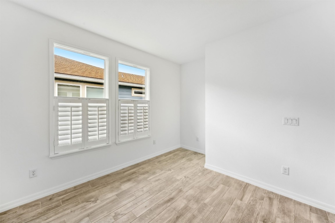 540 Jubilee Circle Yulee, FL 32097 - Photo 11 of 42 a view of an empty room with wooden floor and a window