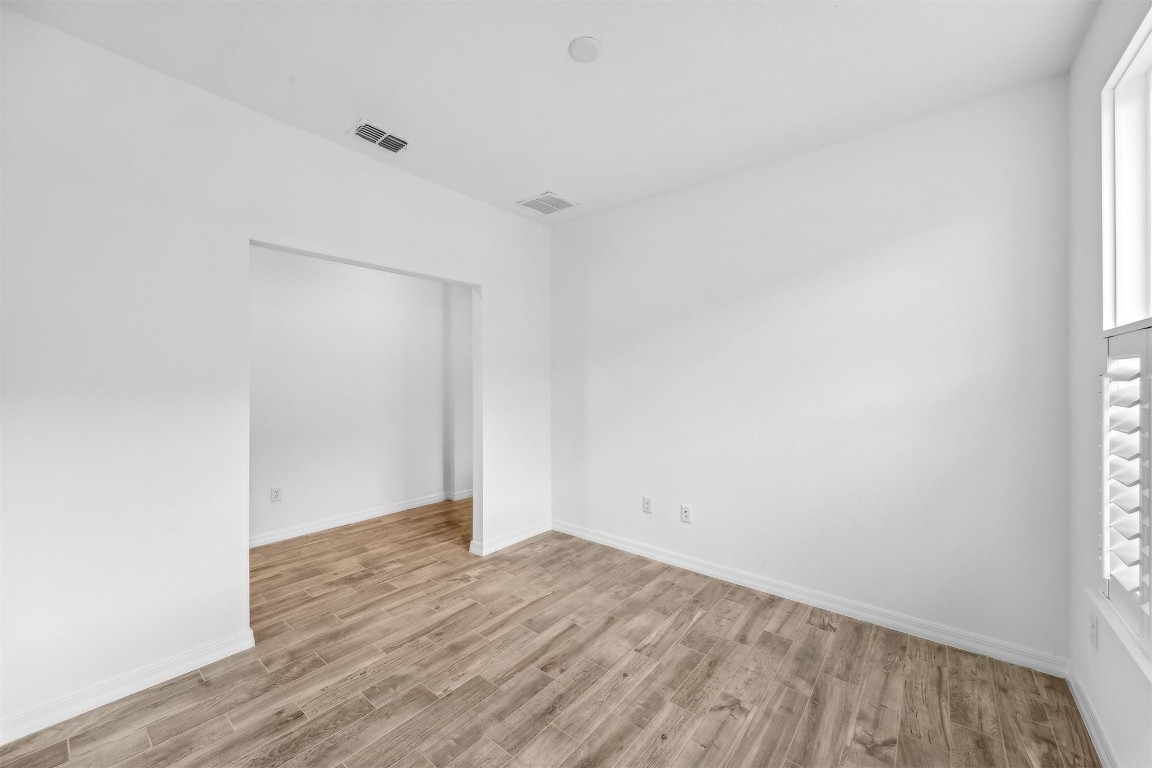 540 Jubilee Circle Yulee, FL 32097 - Photo 12 of 42 a view of an empty room with wooden floor and a window