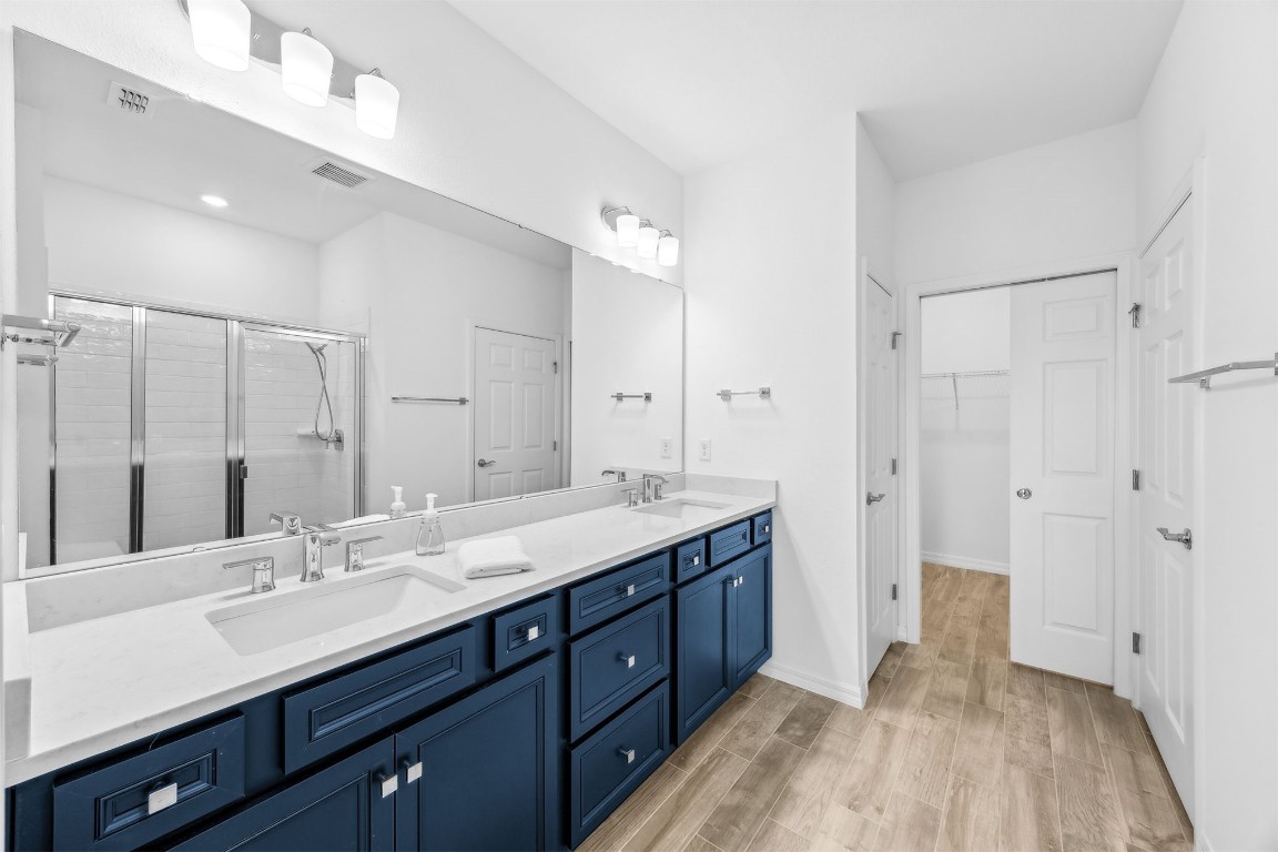 540 Jubilee Circle Yulee, FL 32097 - Photo 14 of 42 a spacious bathroom with a double vanity sink a mirror and a shower
