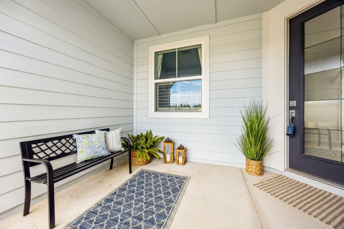 540 Jubilee Circle Yulee, FL 32097 - Photo 2 of 42 a view of a balcony with chairs and wooden floor