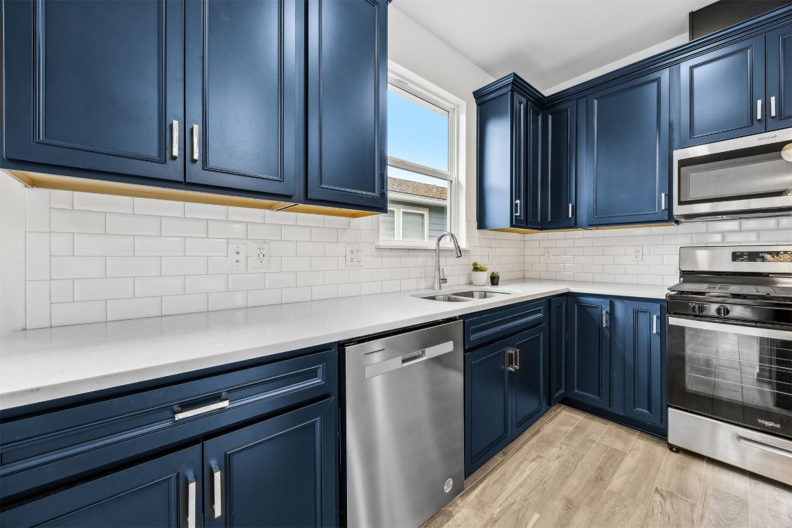 540 Jubilee Circle Yulee, FL 32097 - Photo 5 of 42 a kitchen with stainless steel appliances granite countertop wooden cabinets a sink and dishwasher