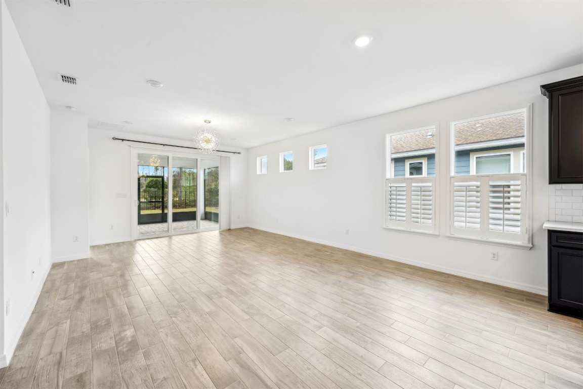 540 Jubilee Circle Yulee, FL 32097 - Photo 9 of 42 a view of an empty room with a window and wooden floor