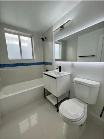 a bathroom with a sink toilet and bathtub