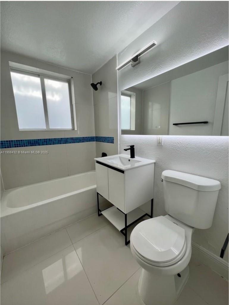 7315 Carlyle Avenue, Unit 10 Miami Beach, FL 33141 - Photo 8 of 9 a bathroom with a sink toilet and bathtub