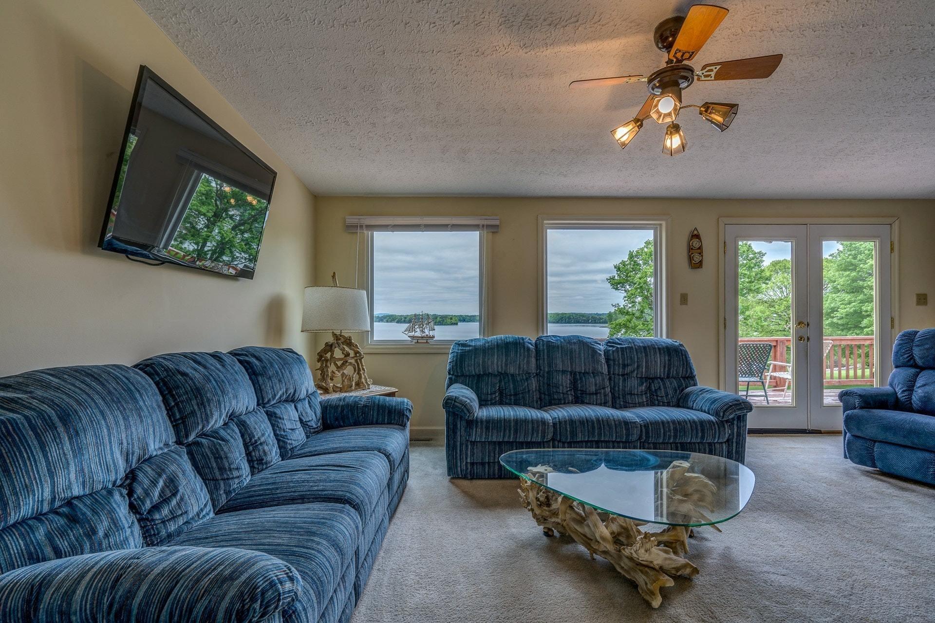 1047 Highland Lake Road Union Hall, VA 24176 - Photo 15 of 39 a living room with furniture ceiling fan and a flat screen tv