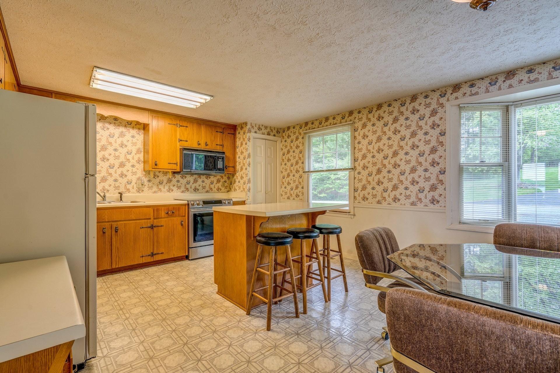 1047 Highland Lake Road Union Hall, VA 24176 - Photo 21 of 39 a view of a dining room with furniture and windows