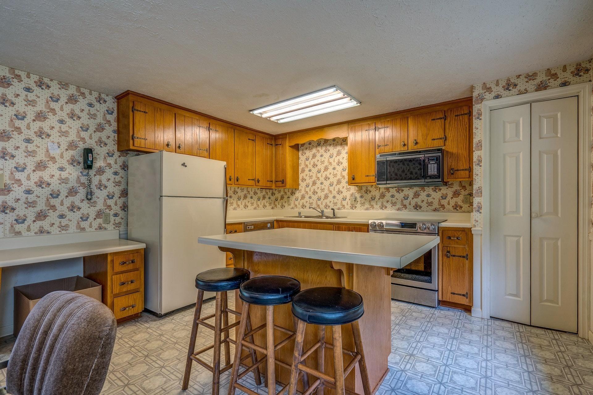 1047 Highland Lake Road Union Hall, VA 24176 - Photo 23 of 39 a kitchen with a refrigerator and a stove top oven