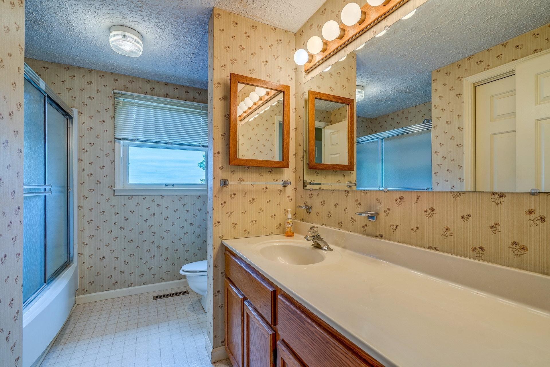 1047 Highland Lake Road Union Hall, VA 24176 - Photo 26 of 39 a bathroom with a sink a toilet and a mirror