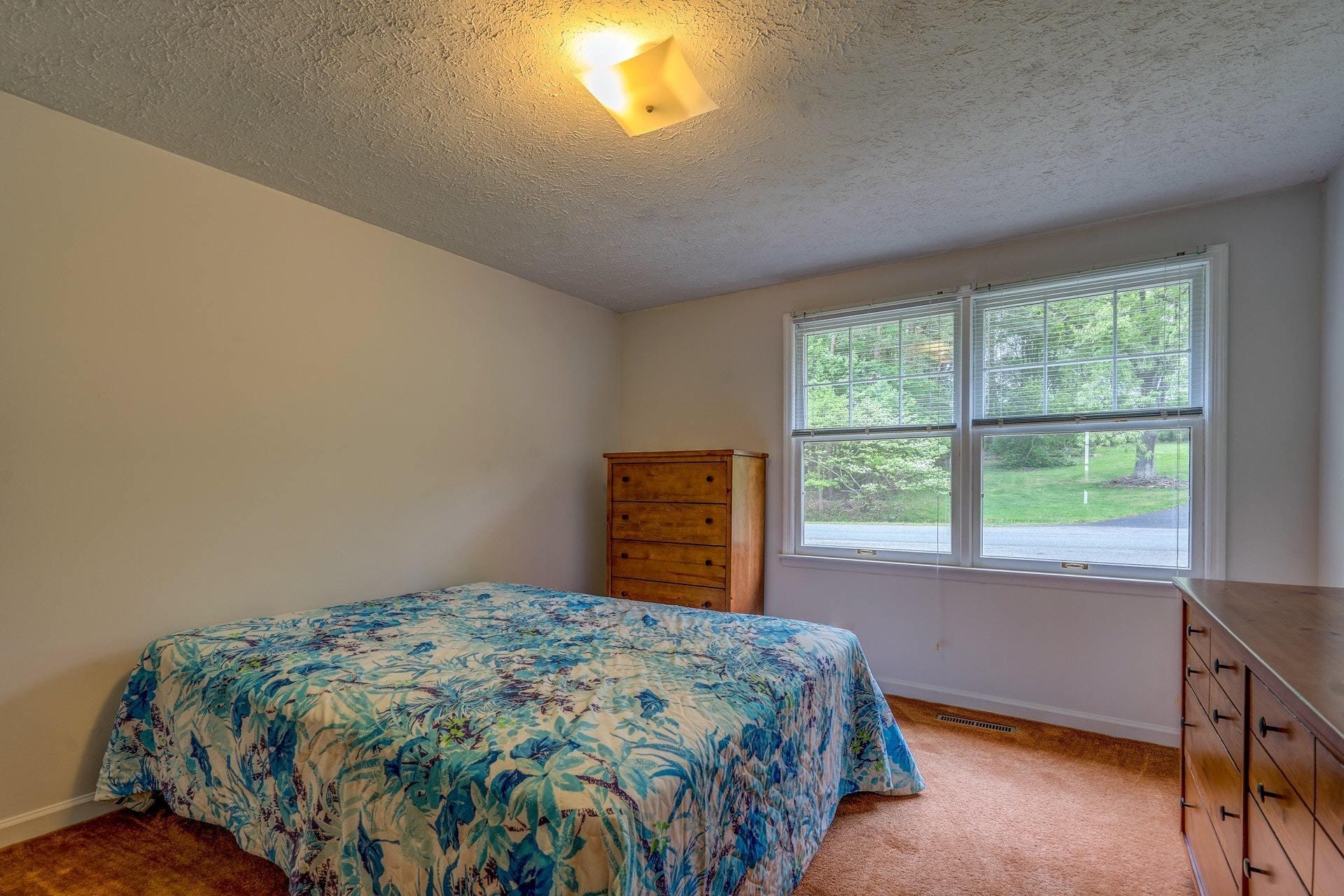 1047 Highland Lake Road Union Hall, VA 24176 - Photo 29 of 39 a bedroom with a bed and a window