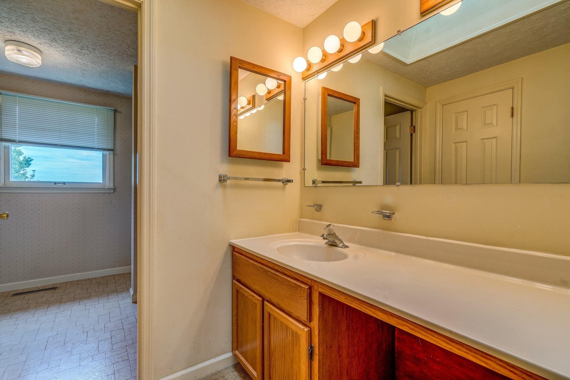1047 Highland Lake Road Union Hall, VA 24176 - Photo 10 of 39 a bathroom with a sink and a mirror