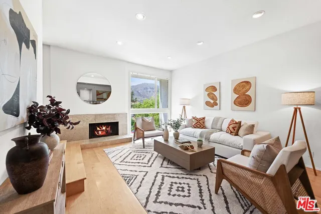 a living room with furniture a fireplace and a table