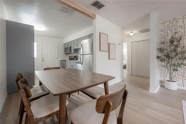 a view of a dining room with furniture and a chandelier