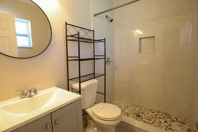 a bathroom with a sink toilet and a mirror