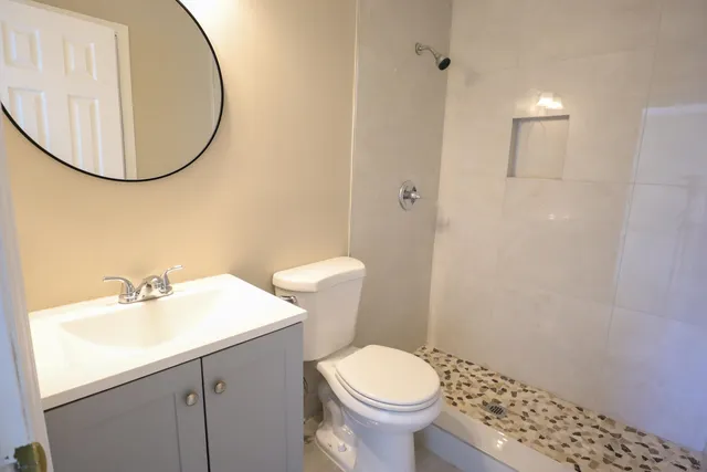 a bathroom with a sink a toilet and a mirror
