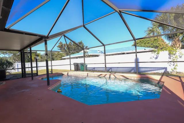 a view of a swimming pool with a patio