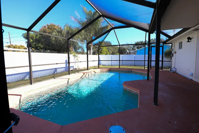 a view of a swimming pool with a patio