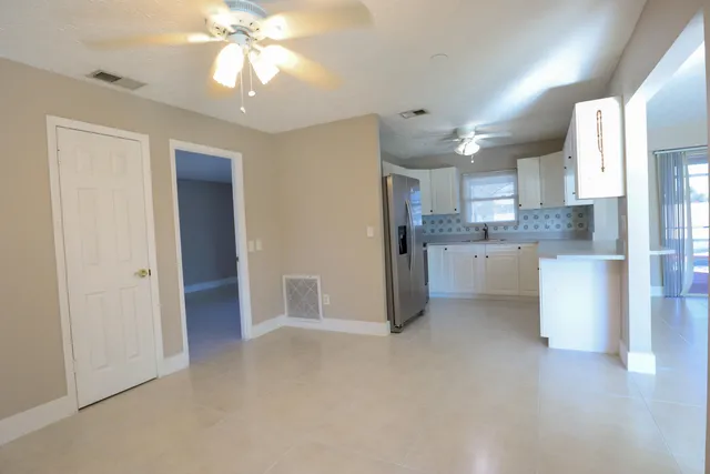 a view of a kitchen with a sink and a refrigerator