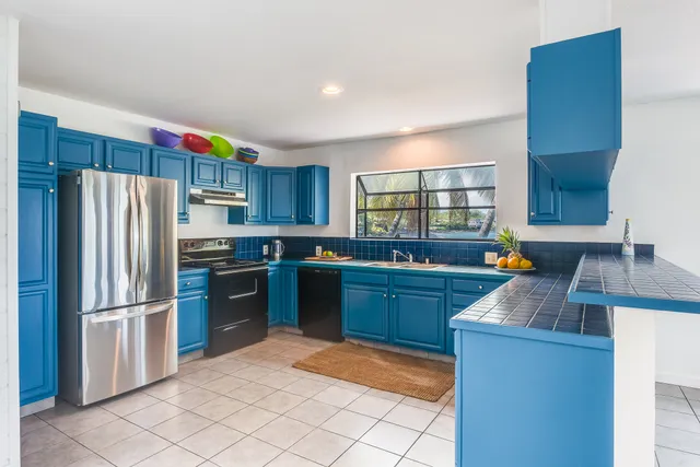 a kitchen with granite countertop a refrigerator and a sink