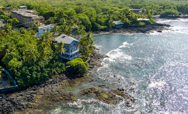a backyard of a house with a yard and outdoor seating