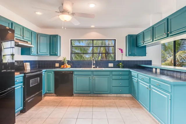 a kitchen with lots of counter top space sink and stainless steel appliances
