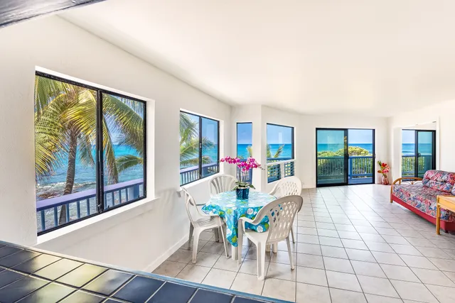 a dining room with furniture and a floor to ceiling window