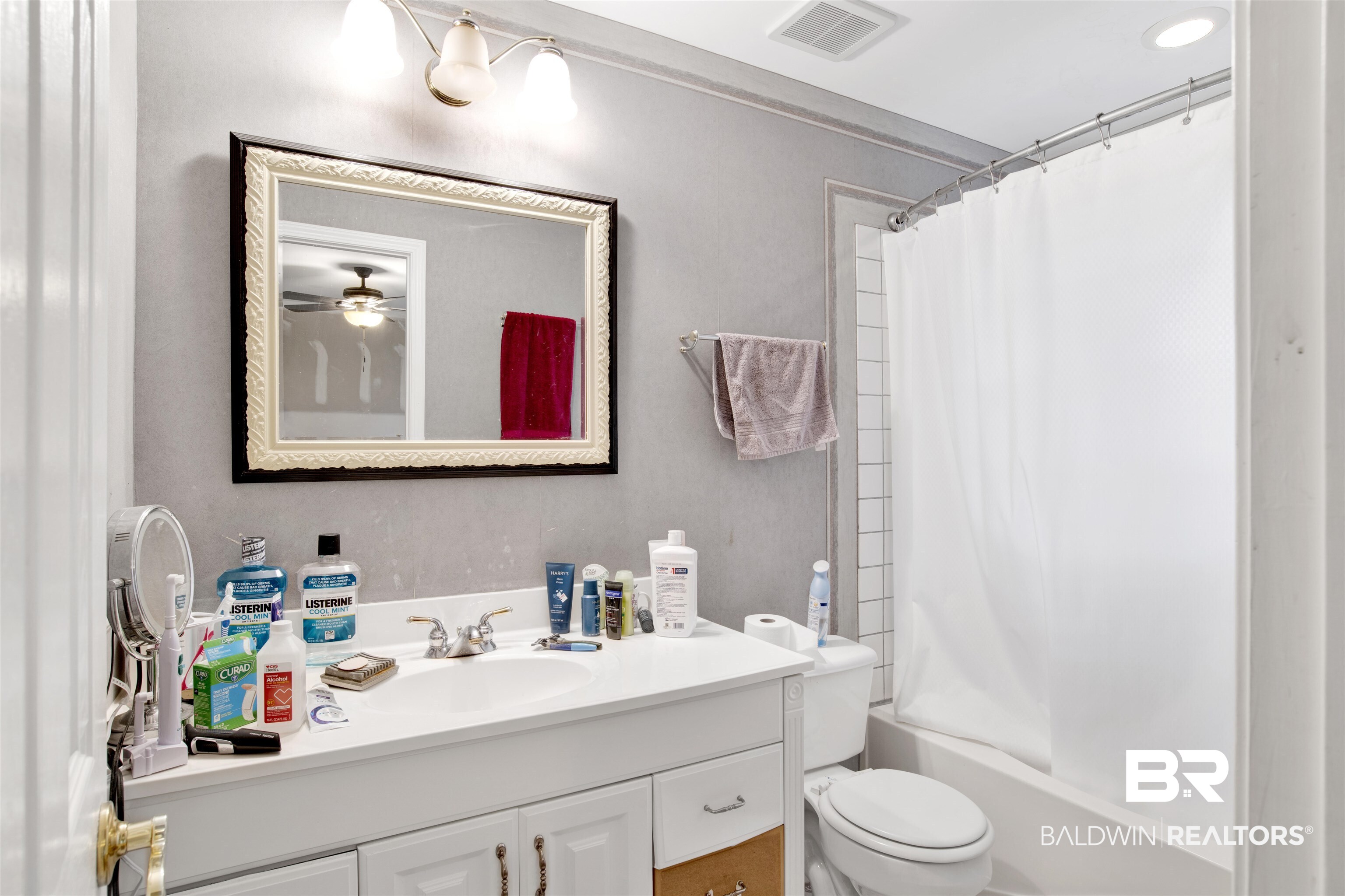 7641 Hitt Road Mobile, AL 36695 - Photo 21 of 29 Full bathroom featuring shower / bathtub combination with curtain, toilet, and vanity