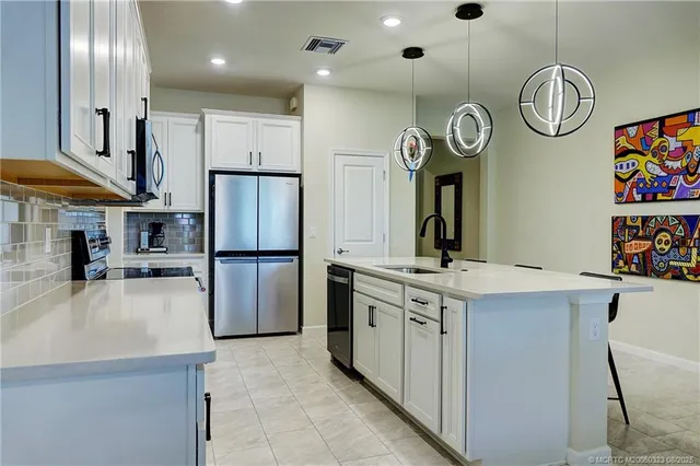 a kitchen with a refrigerator and a sink