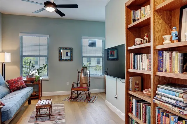 a living room with furniture and a book shelf