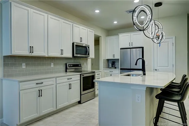a kitchen with cabinets appliances and a sink