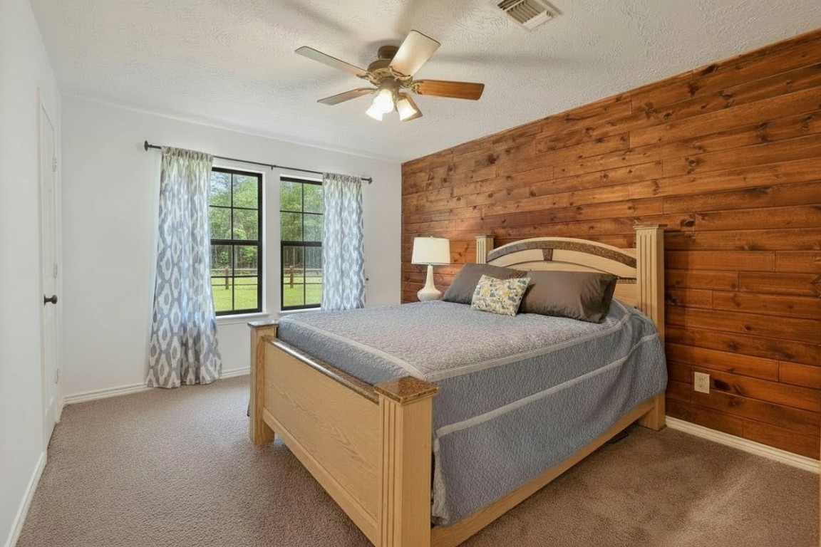 299 North Ghost Branch Road Trinity, TX 75862 - Photo 17 of 48 Beautiful wood accent wall and views of the surrounding forest