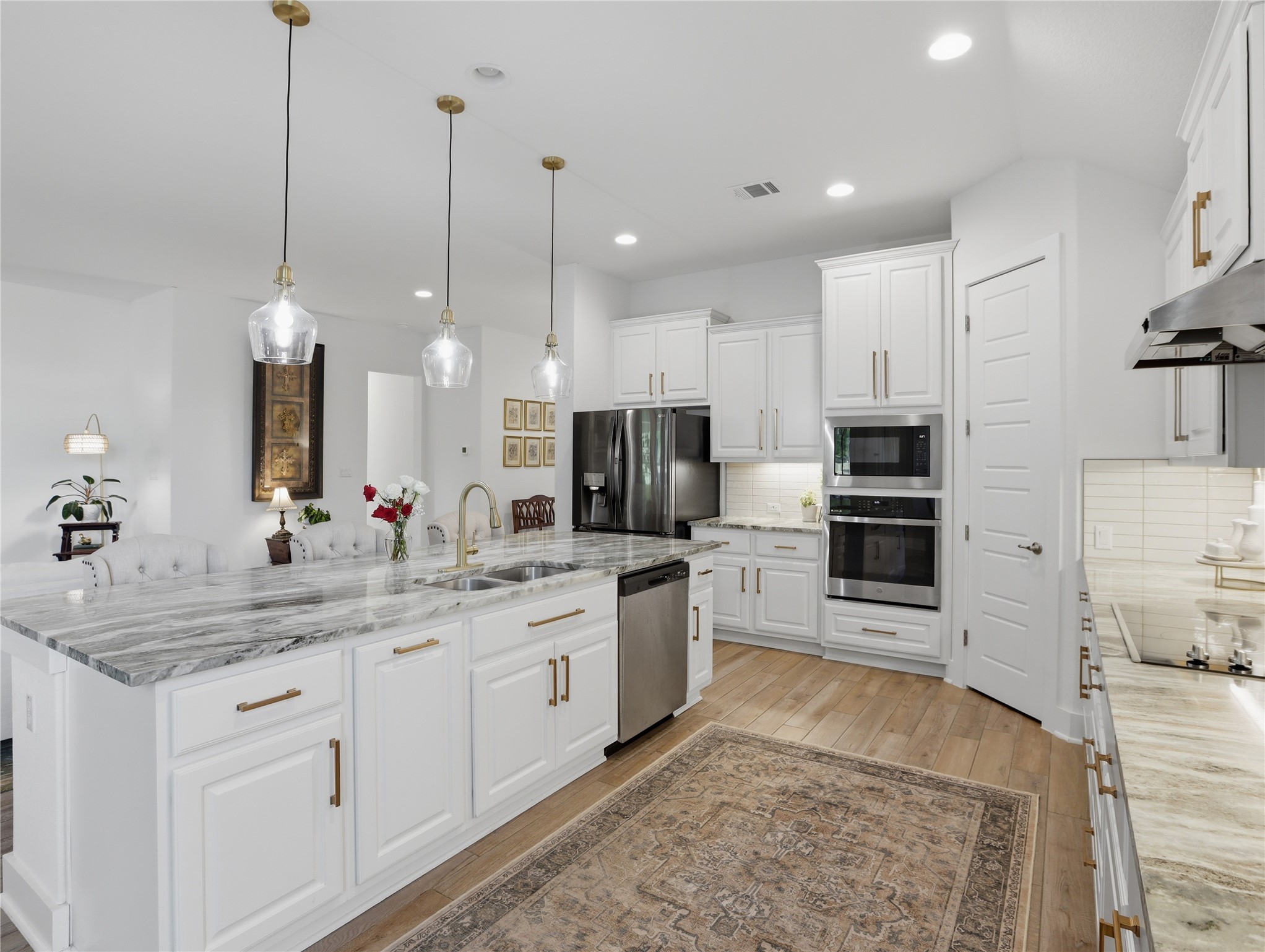 316 Raptor Beak Way Cedar Creek, TX 78612 - Photo 5 of 30 a large kitchen with kitchen island granite countertop a large center island and stainless steel appliances