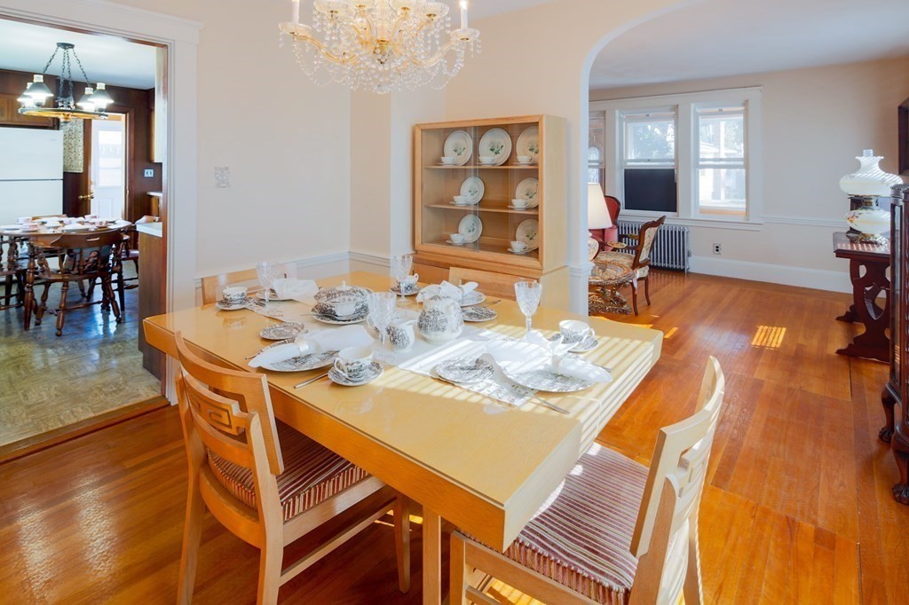 a dining room with furniture and wooden floor