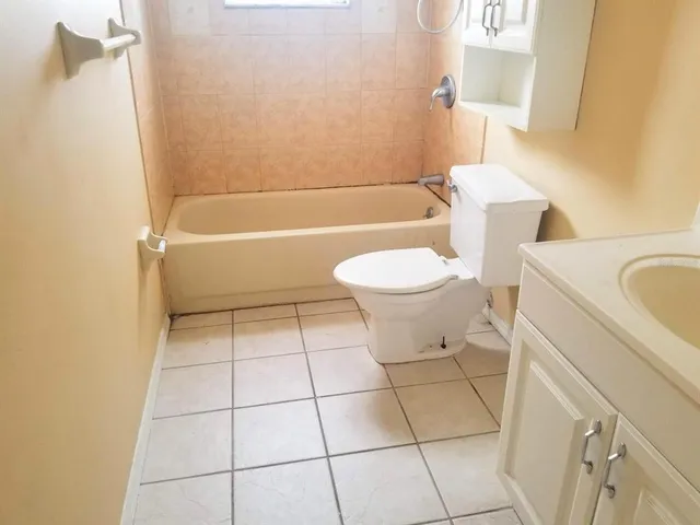 a bathroom with a toilet a sink and bathtub
