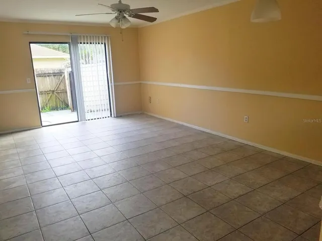 an empty room with a empty space and windows