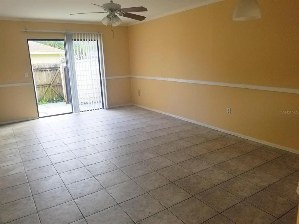 5859 Curry Ford Road, Unit 130 Orlando, FL 32822 - Photo 7 of 7 an empty room with a empty space and windows