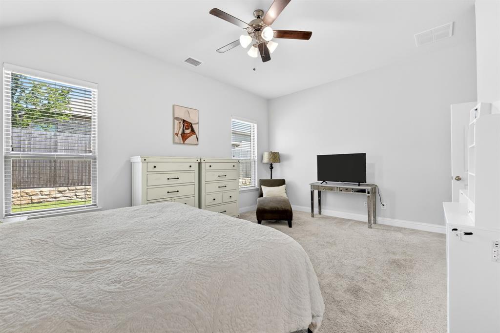 136 Gleeson Drive Red Oak, TX 75154 - Photo 28 of 40 a bedroom with a bed and a flat screen tv