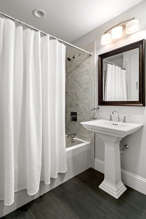 33 Monument Square, Unit 1 Boston, MA 02129 - Photo 11 of 19 a bathroom with a sink a mirror and a bathtub
