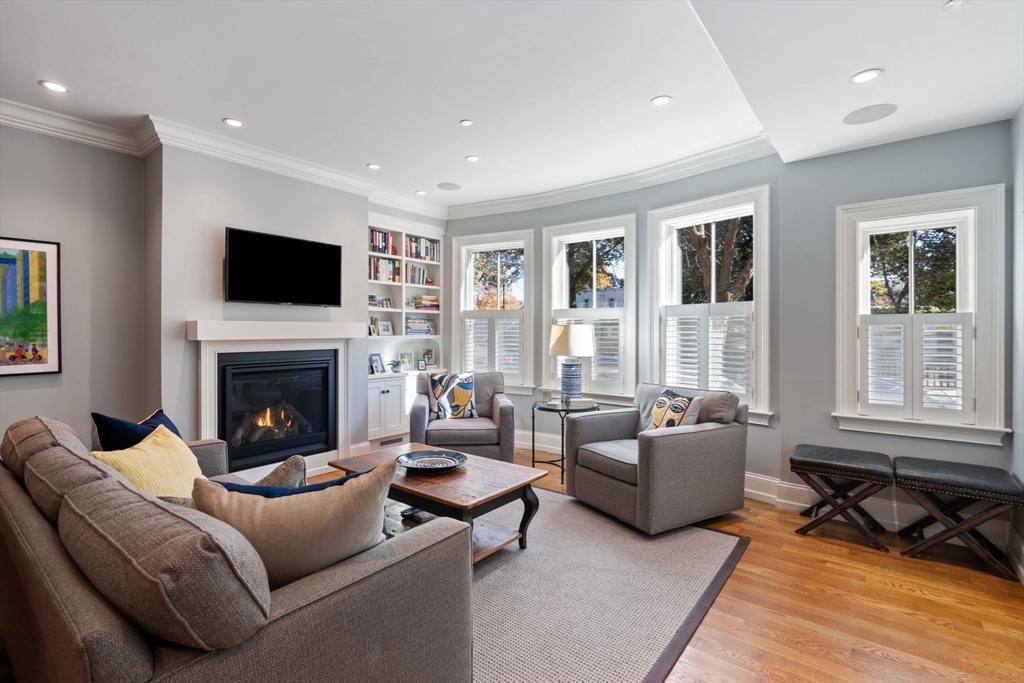 33 Monument Square, Unit 1 Boston, MA 02129 - Photo 16 of 19 a living room with furniture a flat screen tv and a fireplace