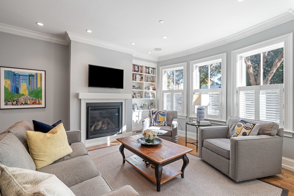 33 Monument Square, Unit 1 Boston, MA 02129 - Photo 2 of 19 a living room with furniture a flat screen tv and a fireplace