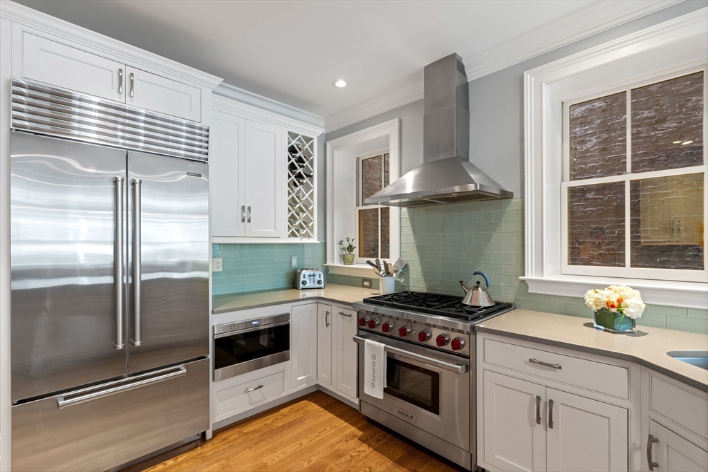 33 Monument Square, Unit 1 Boston, MA 02129 - Photo 5 of 19 a kitchen with granite countertop a stove and a refrigerator