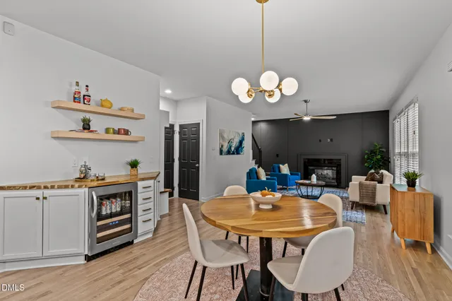 a kitchen with stainless steel appliances granite countertop a sink a stove and a wooden floors