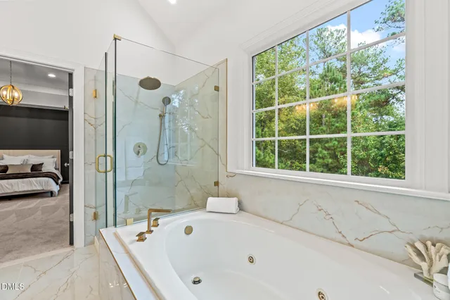 a bedroom with a large bed and a chandelier