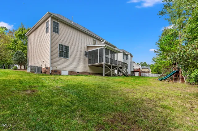 a front view of a house with plants and entryway